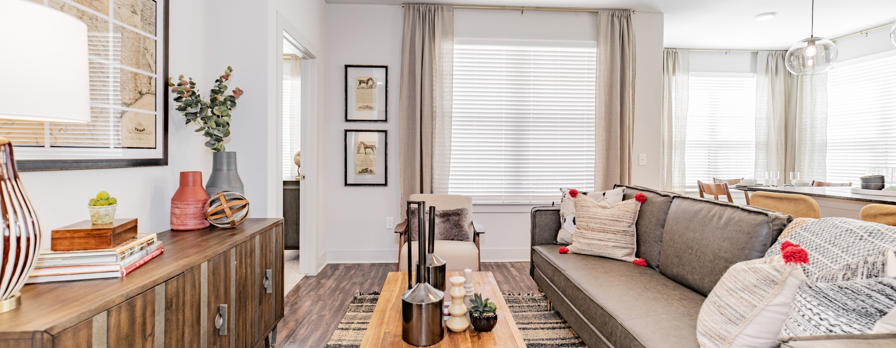 living area with a couch, coffee table and windows