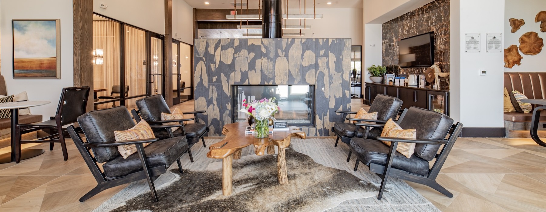 a room with a fireplace and chairs