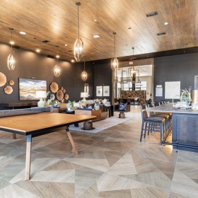 a large room with a ping pong table, tables and chairs
